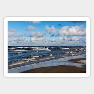 White cumulus clouds in sky over wavy Baltic sea Sticker